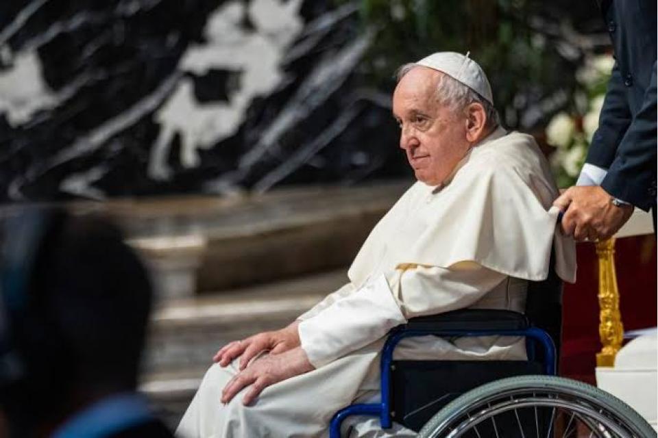 Pope Francis helped to his feet amid health woes, speculation he’ll resign